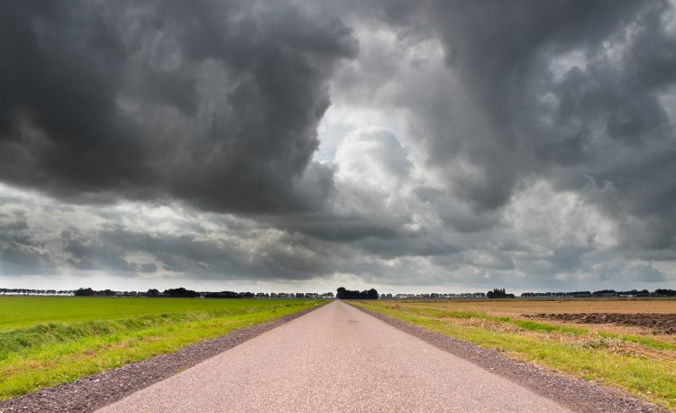 Long Straight Road with Dark Cloudy Sky
